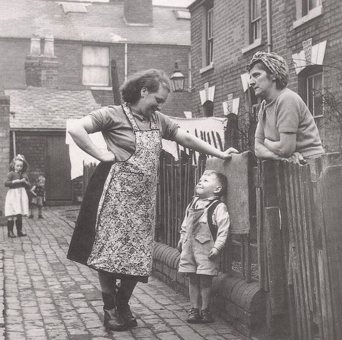 This may contain: an old black and white photo of three people holding hands with a small child in the foreground