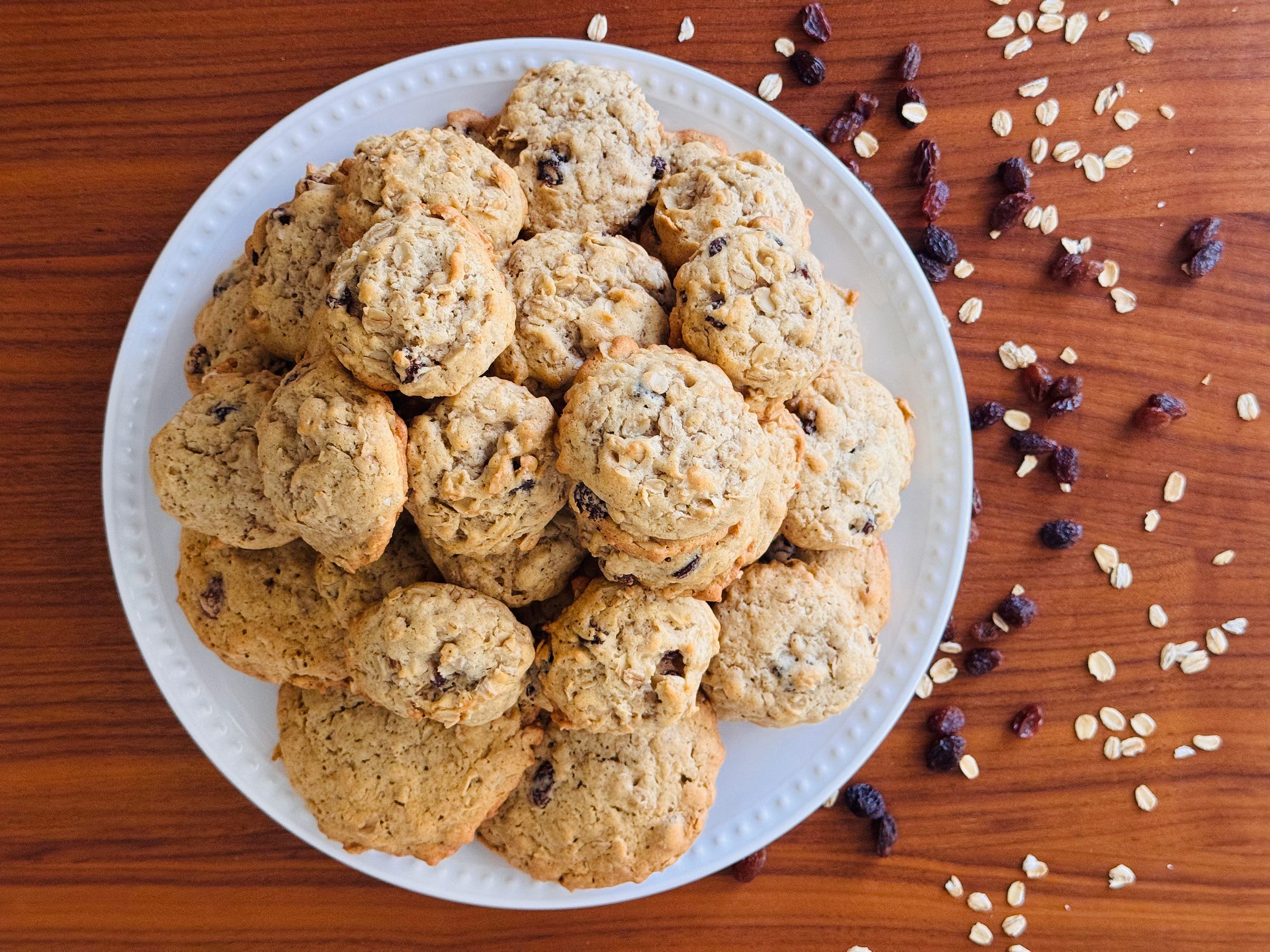 Clara Baker's oatmeal cookies cooling on a baking sheet, golden at the edges, made from her handwritten recipe.