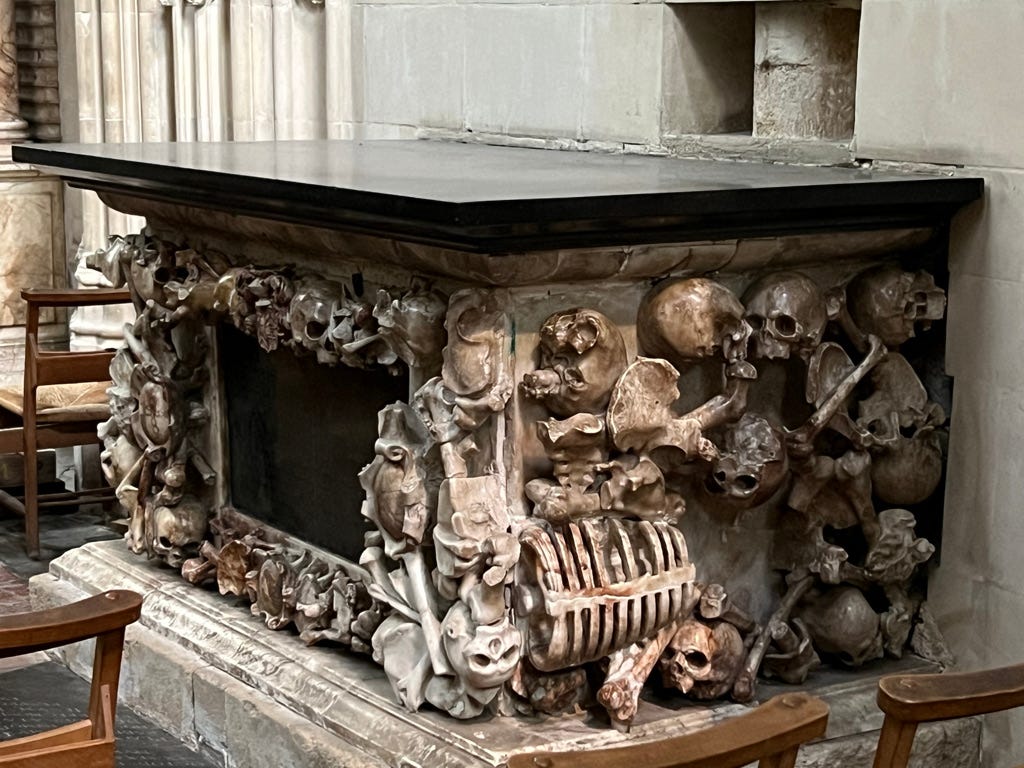 The tomb of Dean Fotherby in Canterbury Cathedral, decorated with a jumble of carved bones and skulls.