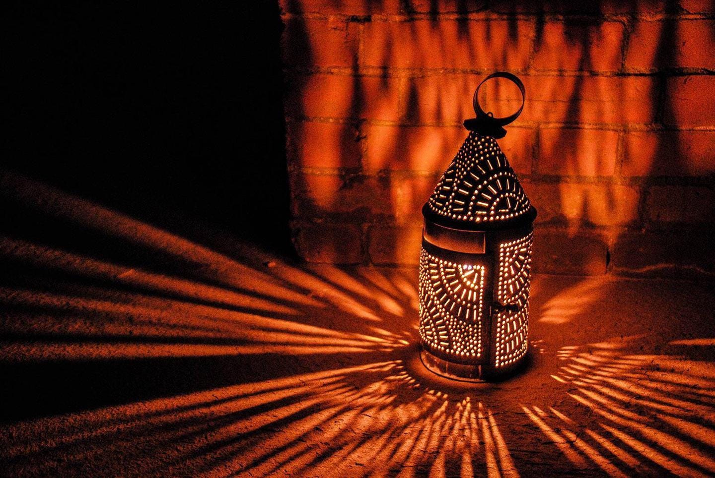 Candle holder with light reflecting through it.