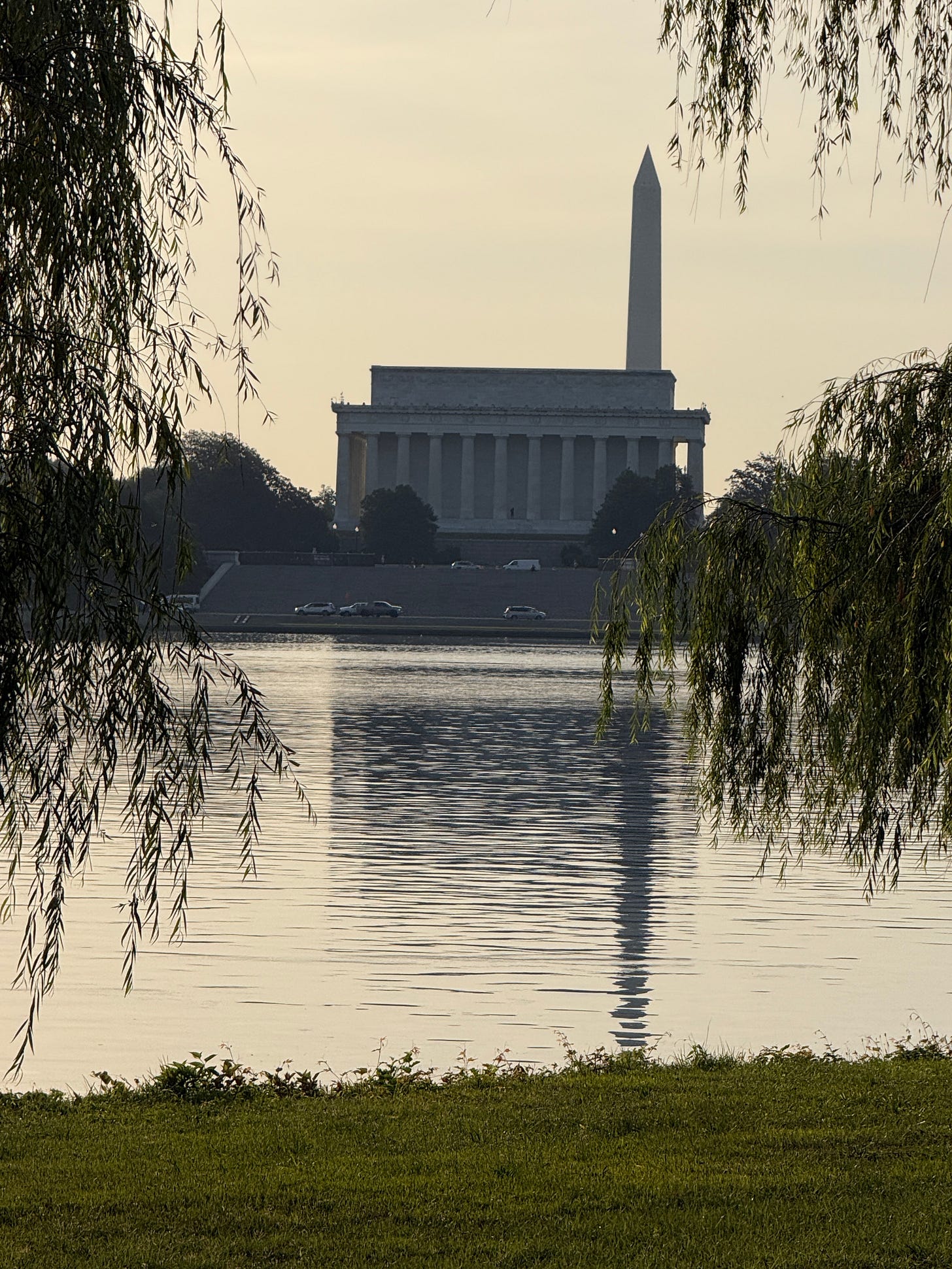 Still water along the Mount Vernon Trail, with the monument in the distance