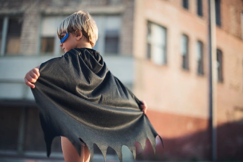 boy wearing black batman cape and mask