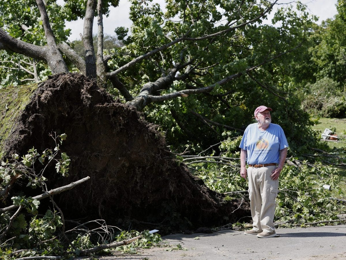 Rare New England tornado lifts car from a highway as strong storms damage homes and flood roads