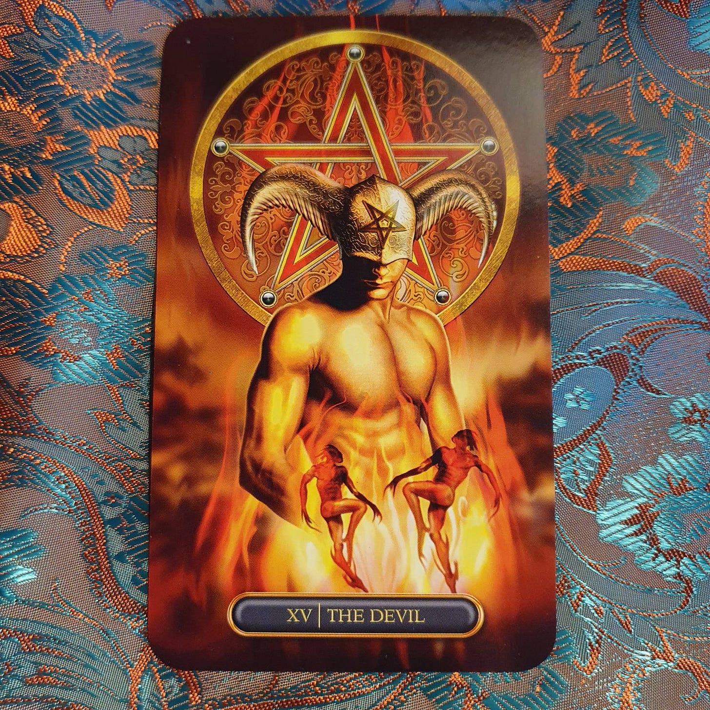 The Devil card on an orange and teal patterned background The Devil card on an orange and teal patterned background