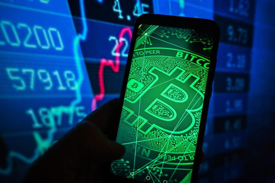 In this photo illustration, a Bitcoin logo is displayed on a... In this photo illustration, a Bitcoin logo is displayed on a...