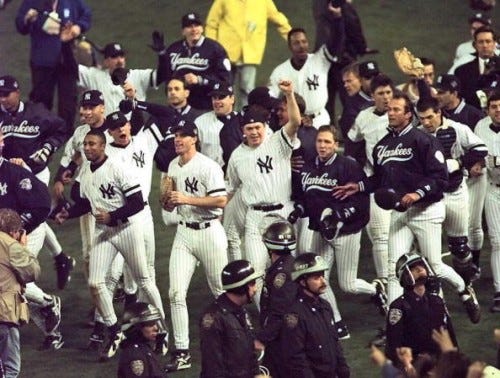 NEW YORK, UNITED STATES: The New York Yankees celebrate 26 October after beating the Atlanta Braves in game six 3-2 to win the World Series at Yankee Stadium in New York. (ELECTRONIC IMAGE) AFP PHOTO/Timothy CLARY (Photo credit should read TIMOTHY A. CLARY/AFP/Getty Images) NEW YORK, UNITED STATES: The New York Yankees celebrate 26 October after beating the Atlanta Braves in game six 3-2 to win the World Series at Yankee Stadium in New York. (ELECTRONIC IMAGE) AFP PHOTO/Timothy CLARY (Photo credit should read TIMOTHY A. CLARY/AFP/Getty Images)