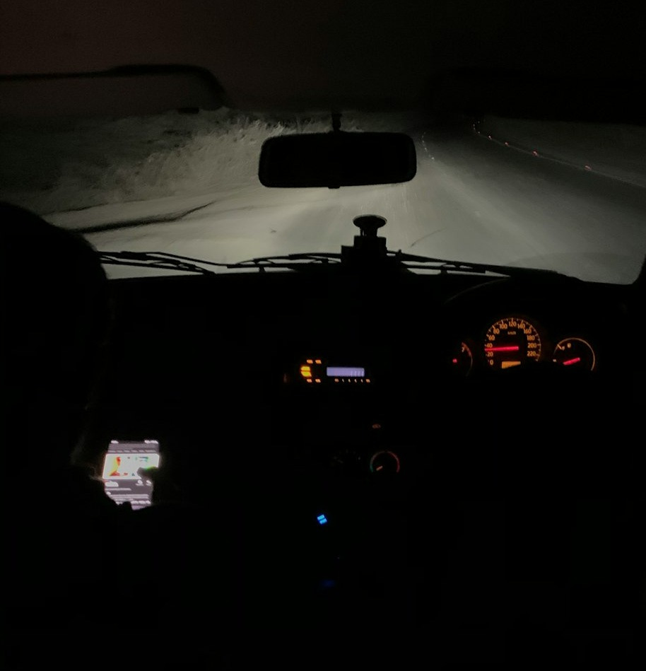a view of the dashboard of a car in the dark