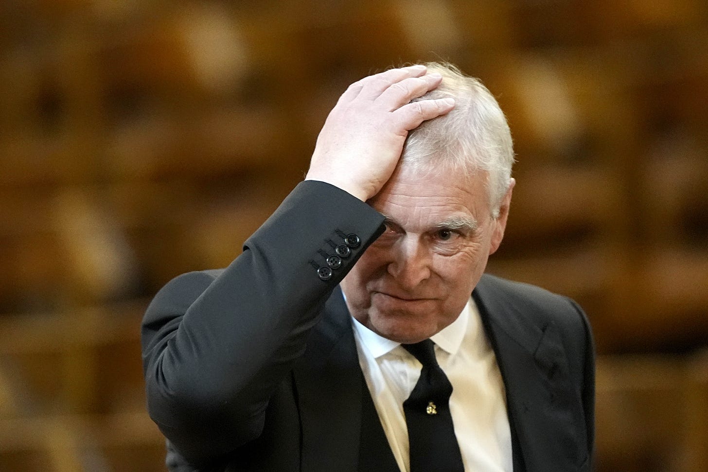 Andrew Mount-Batten Windsor holding his head in despair