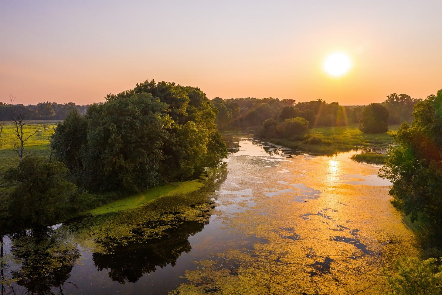Sun rise over a river in a morning.