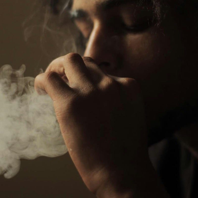 man smoking cigarette in grayscale photography man smoking cigarette in grayscale photography