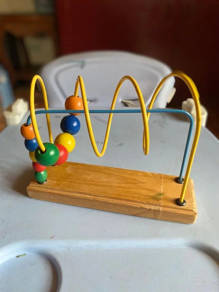 Educational loop toy with beads to help improve the focus of children with GDD