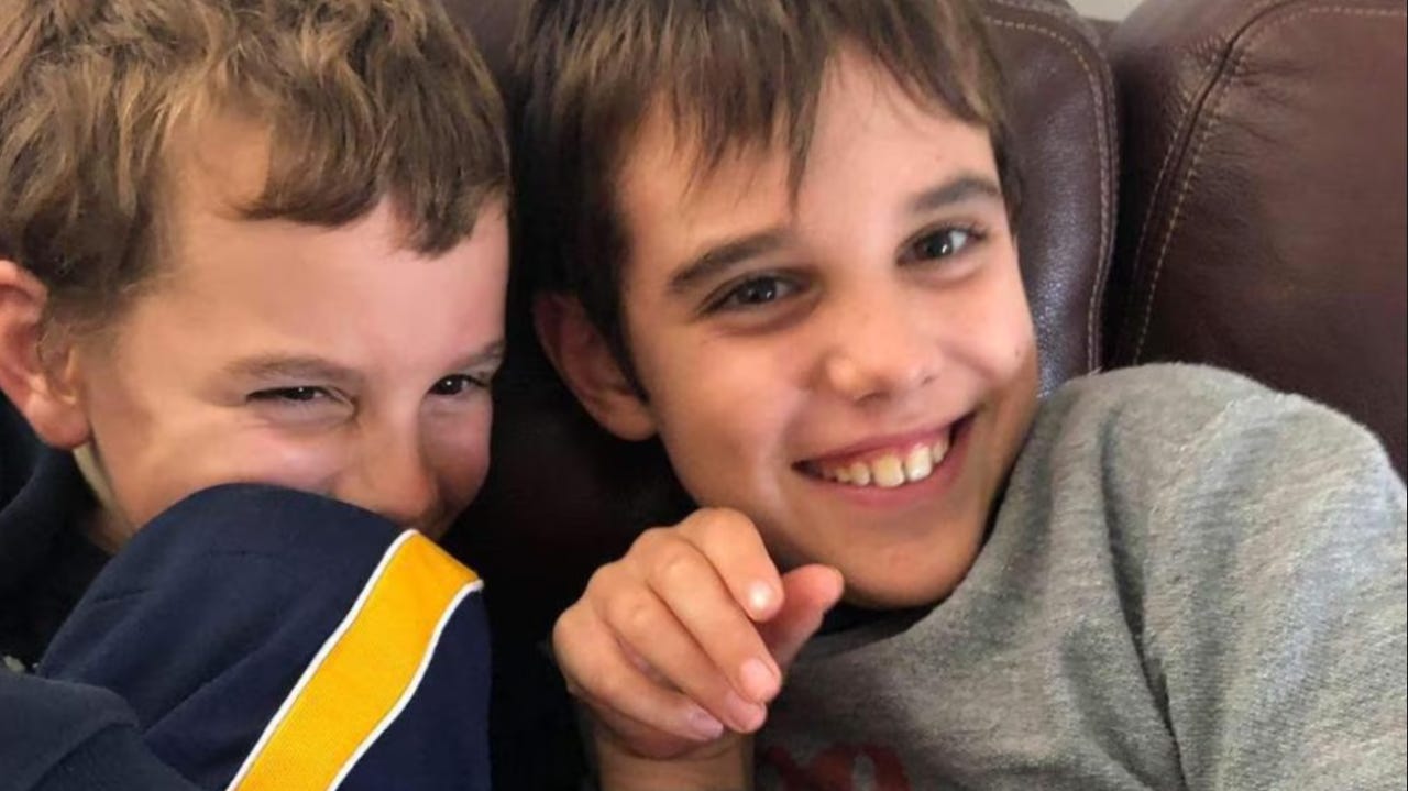 Otis and Leon Clune, brothers, heads close together and smiling, in younger years. The boys were 14 and 16 when their parents murdered them.