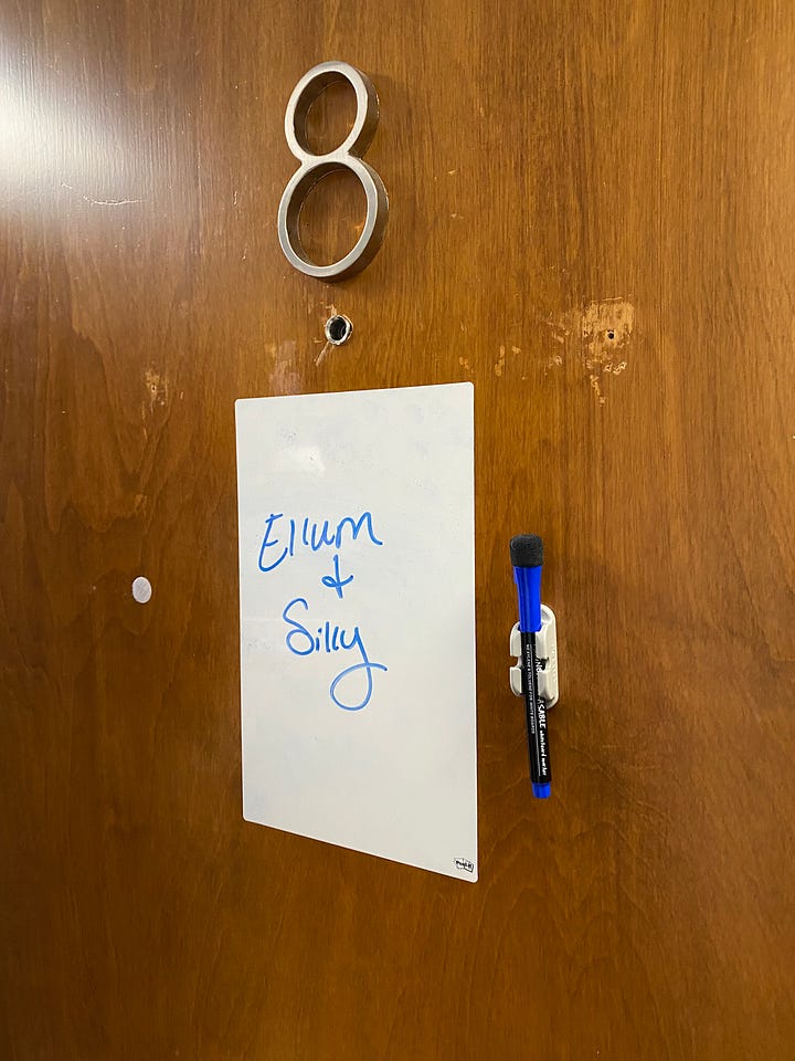 A photo showcasing the door with the sign for Ellum and Silly, and images of Andrea and Kelsey holding Ellum for the last time, and a photo of Ellum right after he passed laying on the sweet knitted blanket