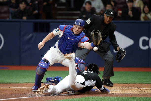 Kim Hye-seong of Team Korea slides safely into the home by a sacrifice fly of Kang Baek-ho in the 3rd inning during the exhibition game between Team... Kim Hye-seong of Team Korea slides safely into the home by a sacrifice fly of Kang Baek-ho in the 3rd inning during the exhibition game between Team...