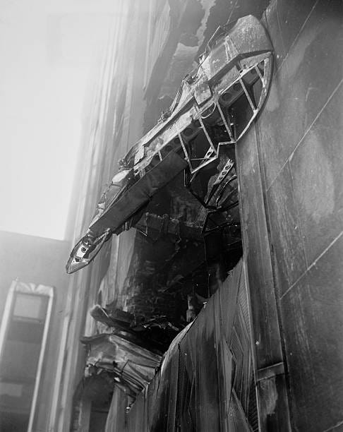Parts of a B-25 Mitchell bomber protruding from a large hole between the 78th and 79th floors of the Empire State Building after the plane crashed... Parts of a B-25 Mitchell bomber protruding from a large hole between the 78th and 79th floors of the Empire State Building after the plane crashed...