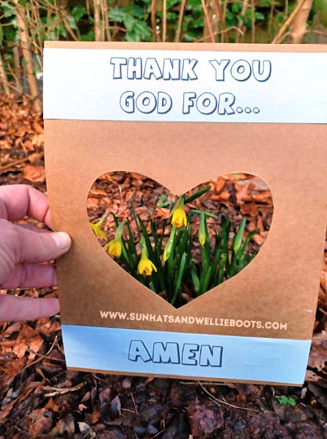 yellow crocuses are framed by a brown cardboard heart. Above the heart is the text, "Thank you God for..." and below it reads "Amen."
