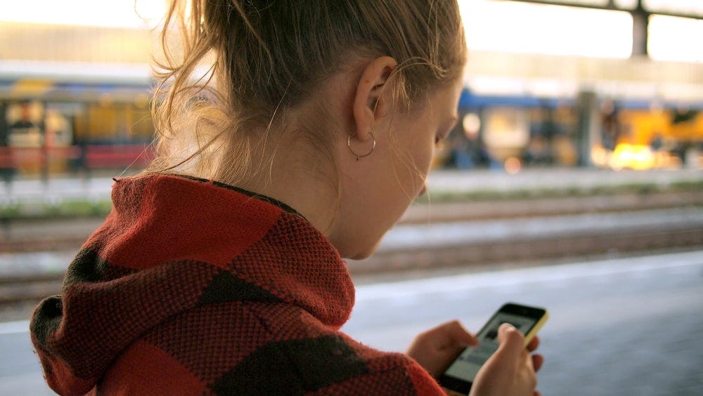 woman holding phone woman holding phone