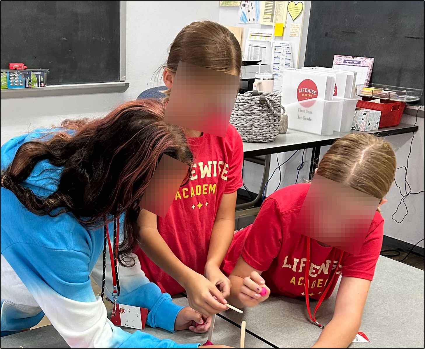 LifeWise Elmwood students in front LifeWise teacher's desk on Elmwood Local School District public property.