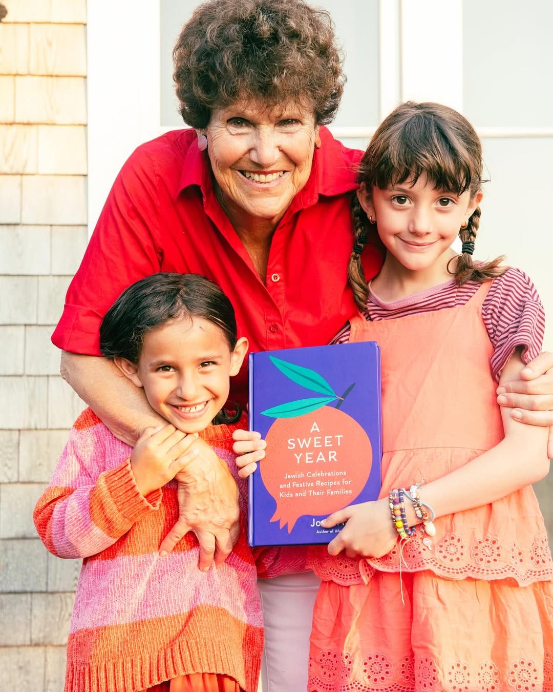 Joan Nathan and her grandkids hold her book A Sweet Year Joan Nathan and her grandkids hold her book A Sweet Year