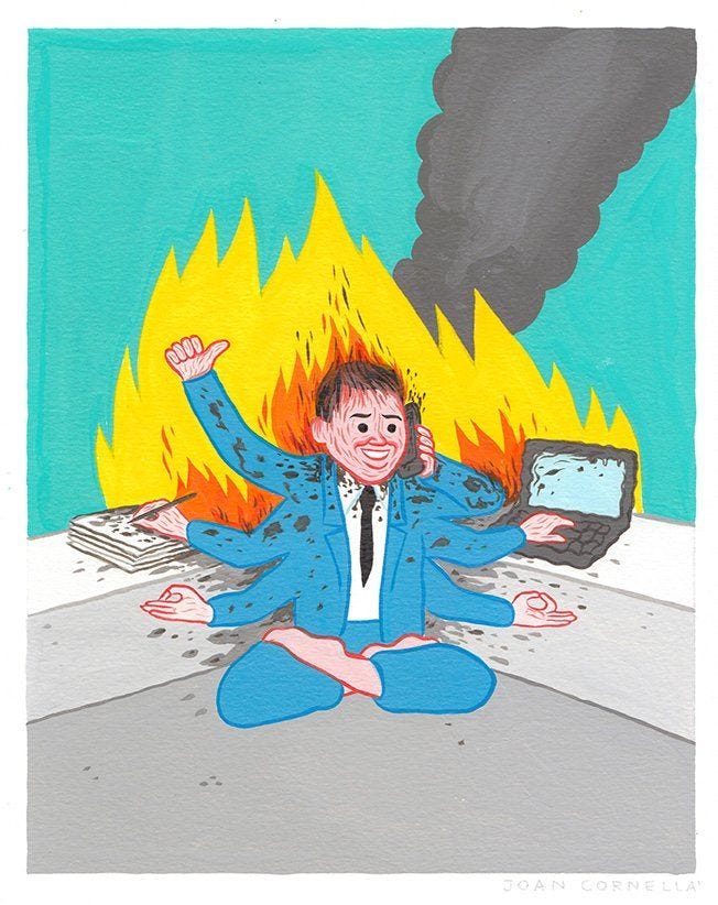 This may contain: a man sitting in front of a laptop computer on fire