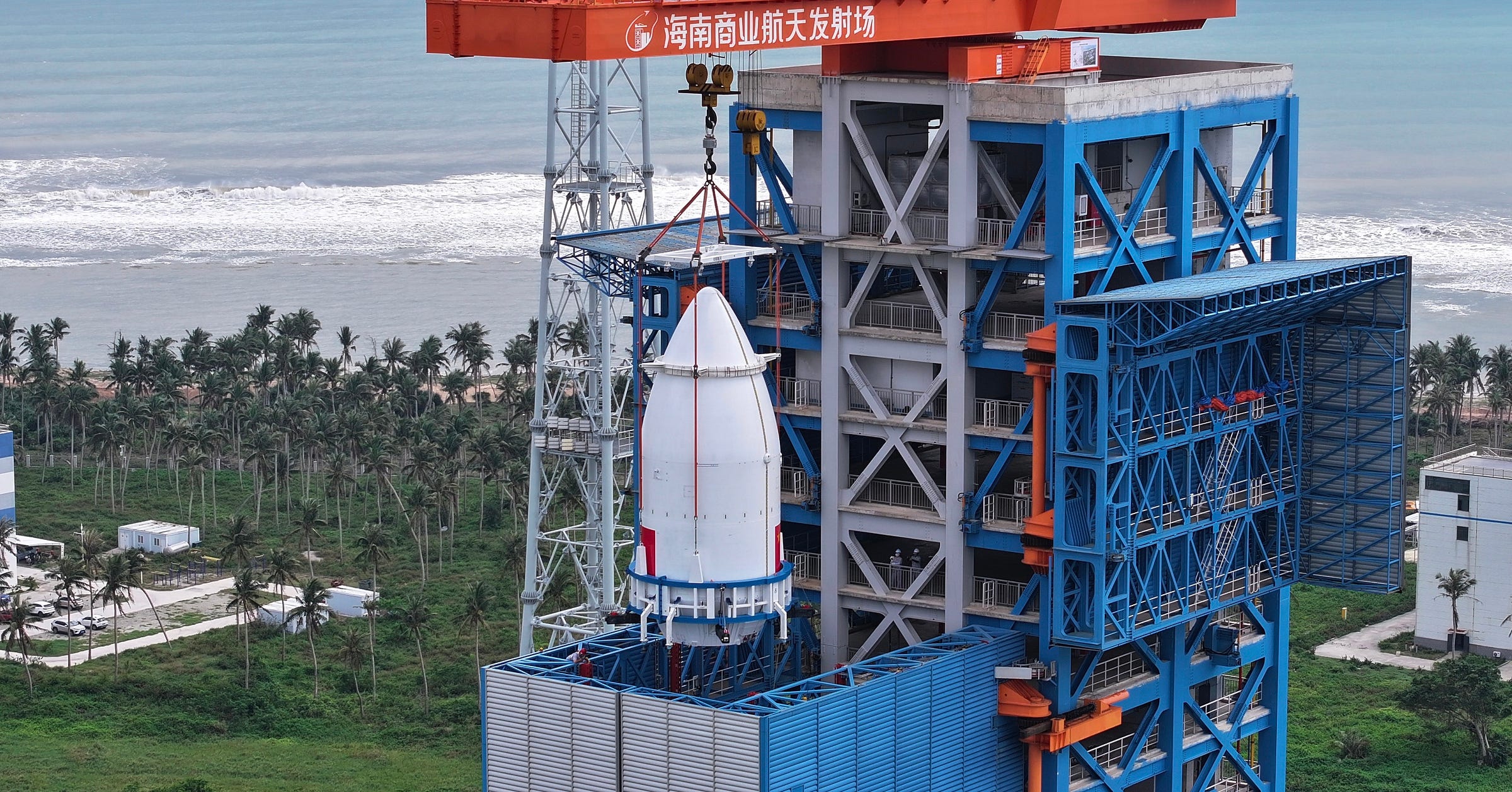 The payload fairing of the Long March 8A Y5 vehicle being lifted, with nine GuoWang satellites inside, atop of the rest of the launch vehicle ahead of a December 6th 2025 mission from the Wenchang Commercial Space Launch Site.