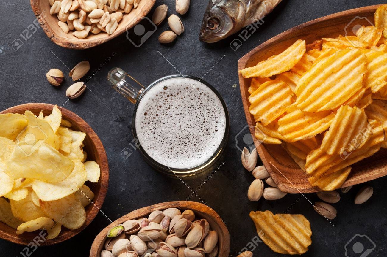 Lager Beer Mug And Snacks On Stone Table. Nuts, Chips, Dry Fish. Top View  Stock Photo, Picture and Royalty Free Image. Image 74719331.