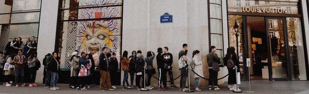 people queuing beside Louis Vuitton store people queuing beside Louis Vuitton store