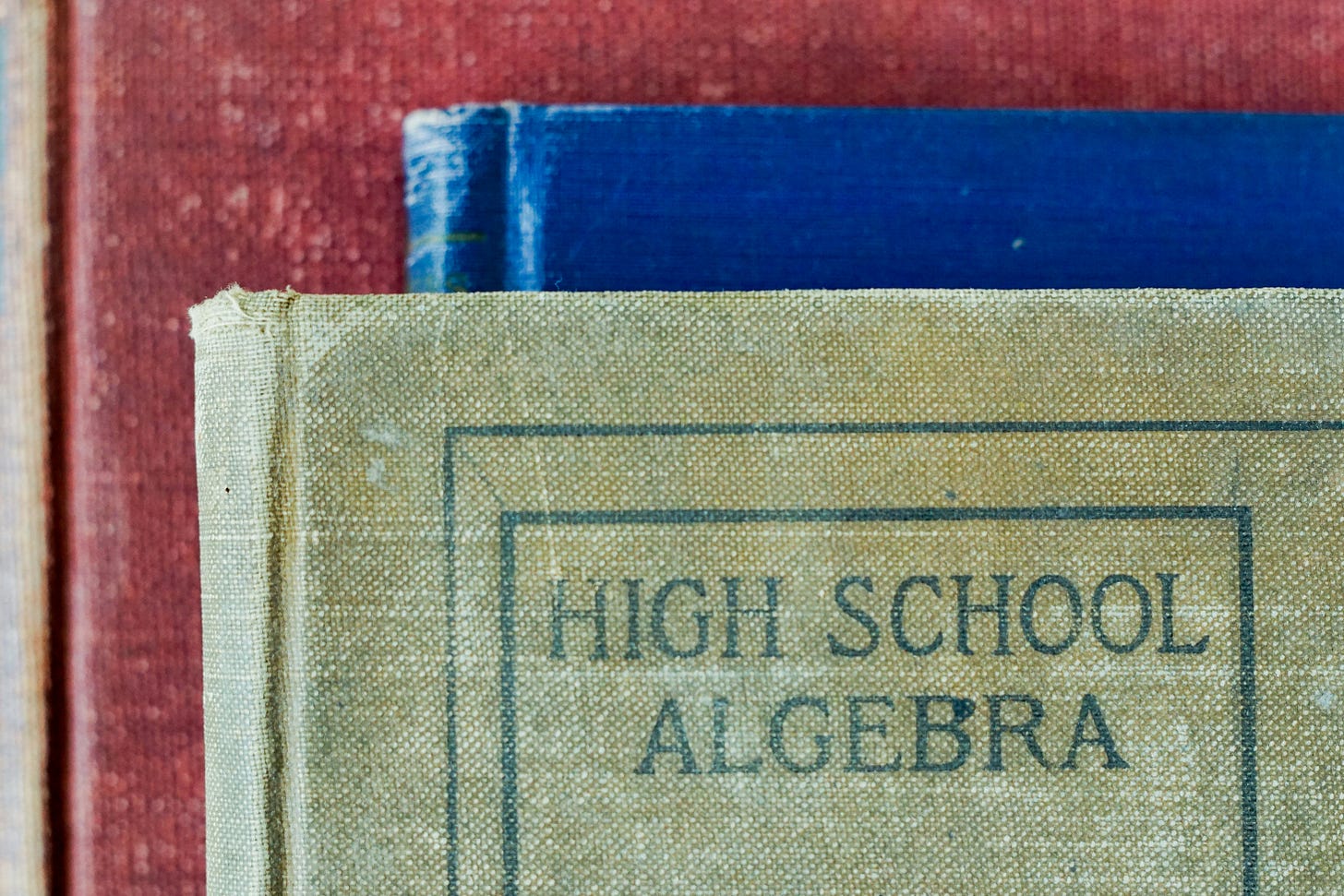 photo of three ancient looking textbooks
