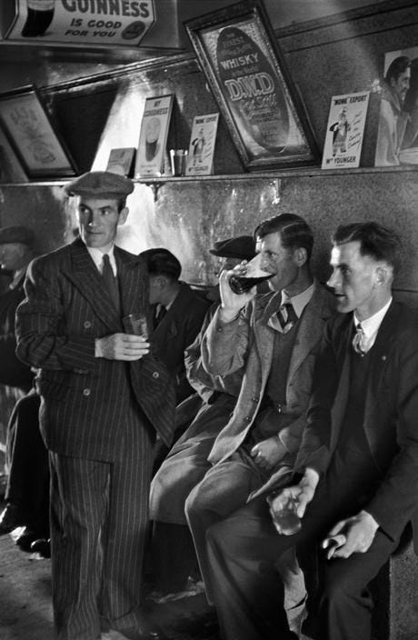 This may contain: black and white photograph of men in suits drinking This may contain: black and white photograph of men in suits drinking