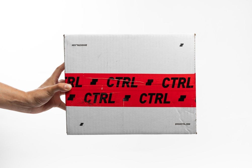 person holding white and red box