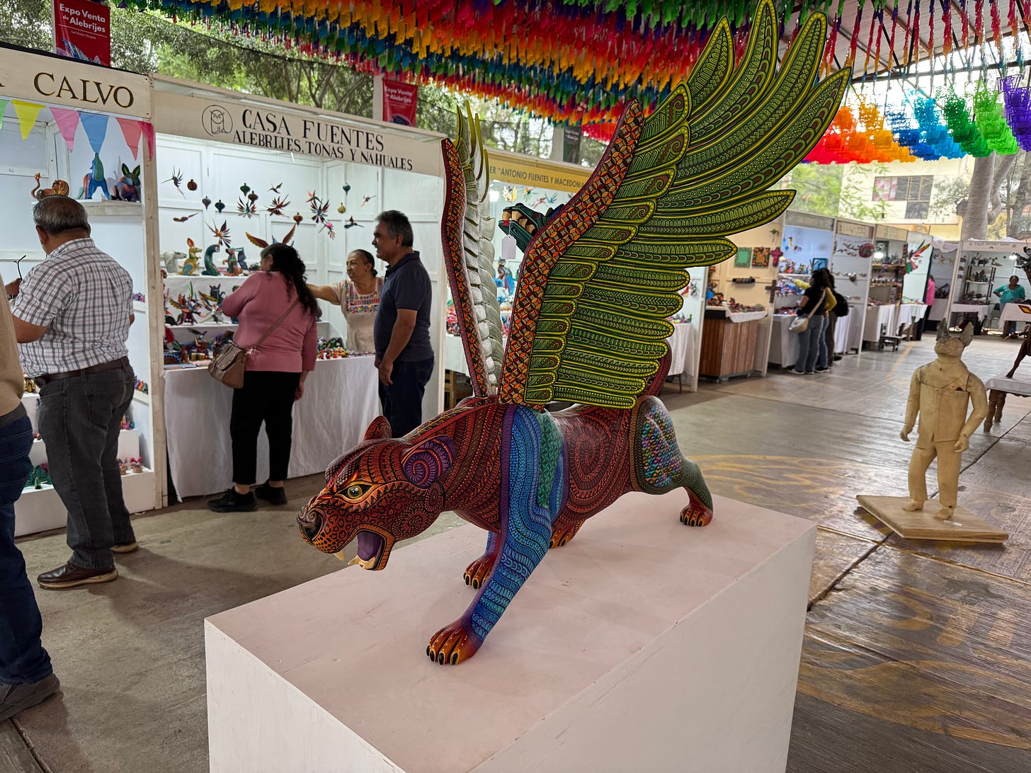 A large alebrije statue of a jaguar with wings.