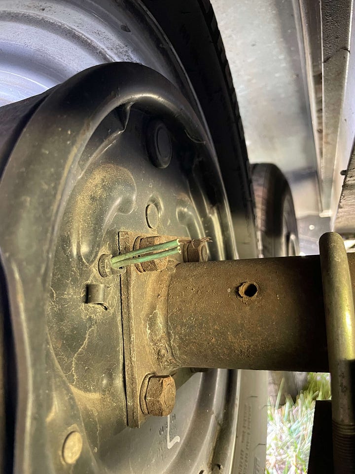 Photo 1- Disconnected brake wires; Photo 2- Cassidy laying on the ground under the camper wearing a pink tank top rewiring the brakes