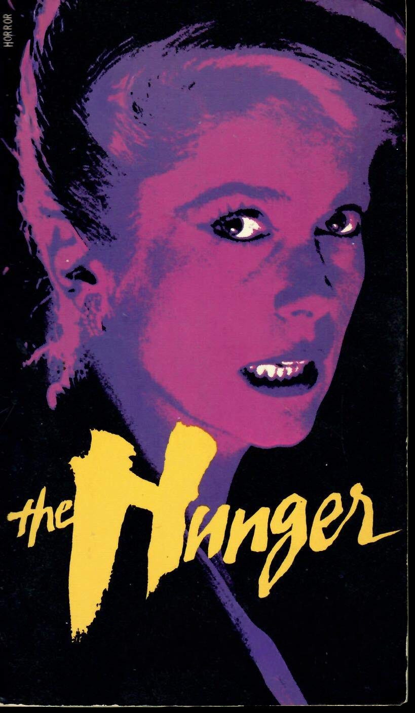 Purple and magenta-toned photo of French vampire with teeth and whites of eyes contrastingly white