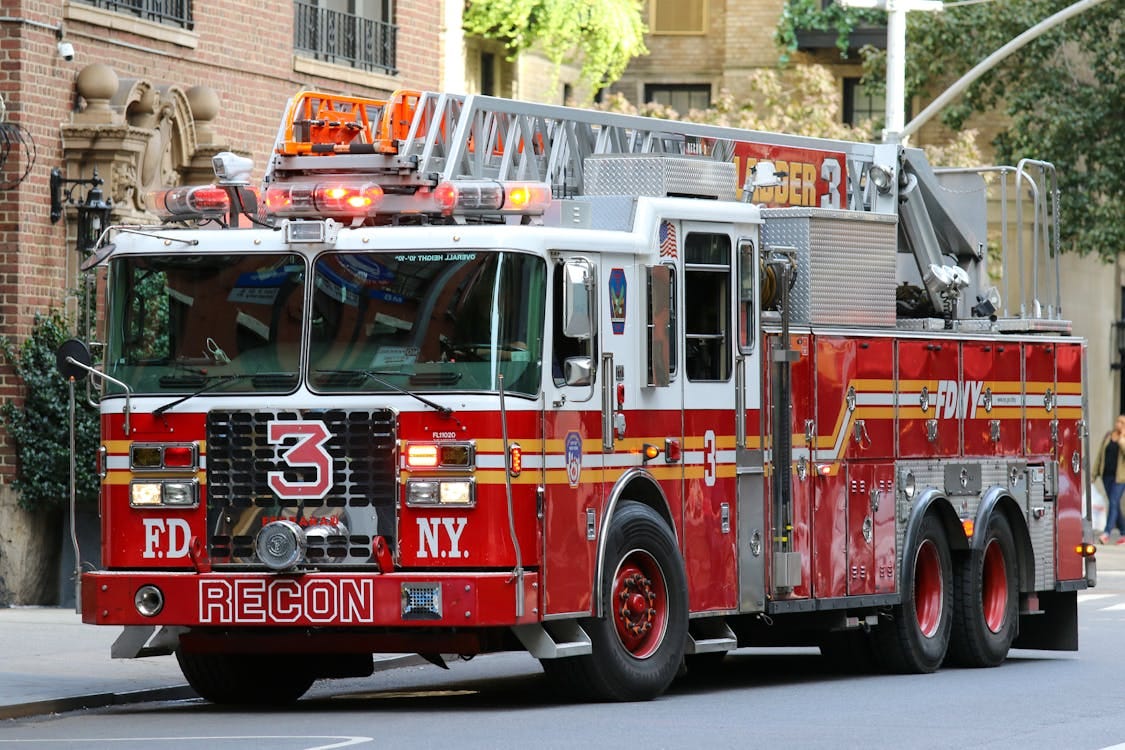 Free FDNY fire truck parked on city street, vibrant urban scene. Stock Photo