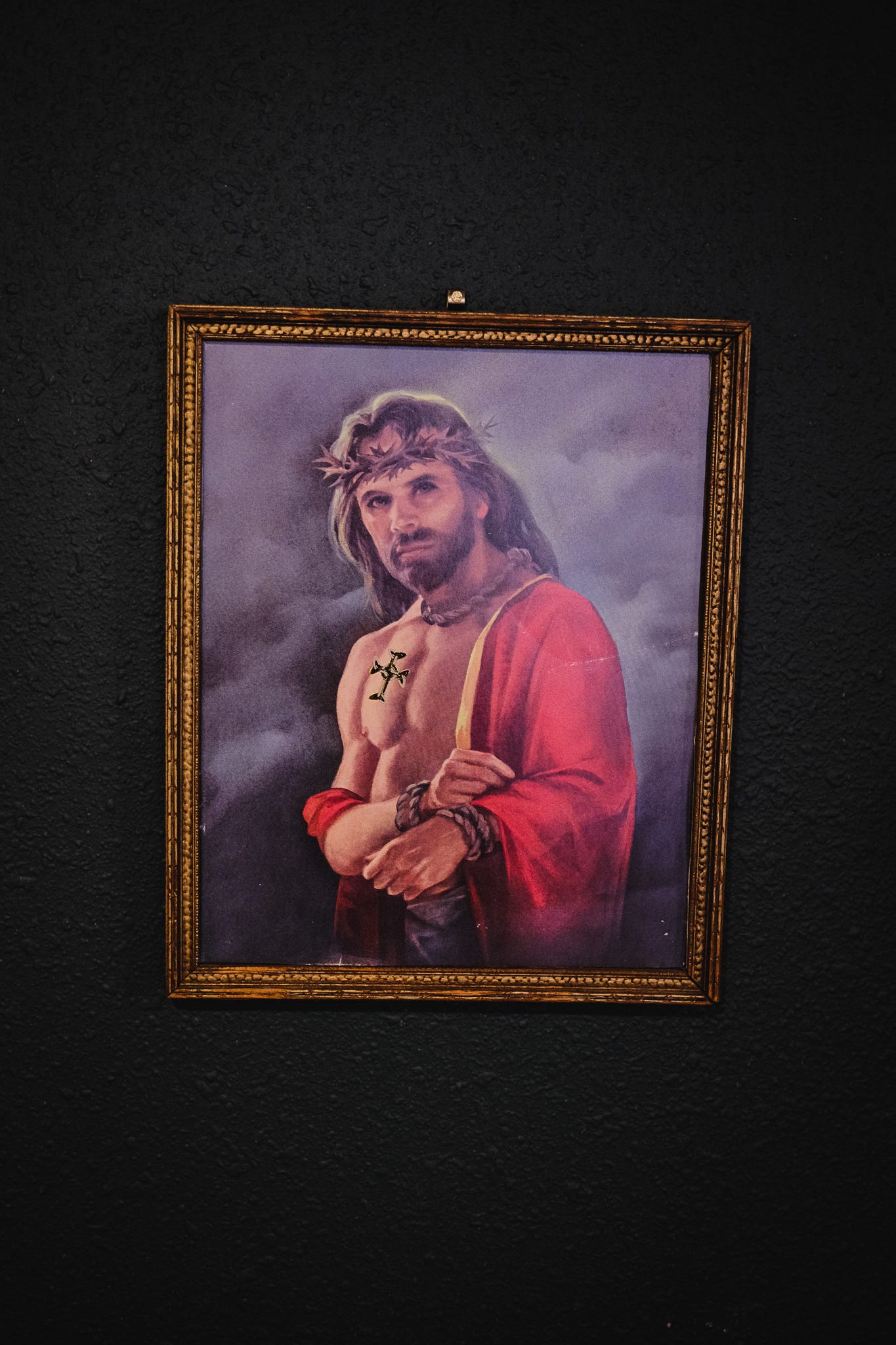 a picture of JEsus with long hair, white skin, a crown of thorns on his head, and really buff pecs for some reason