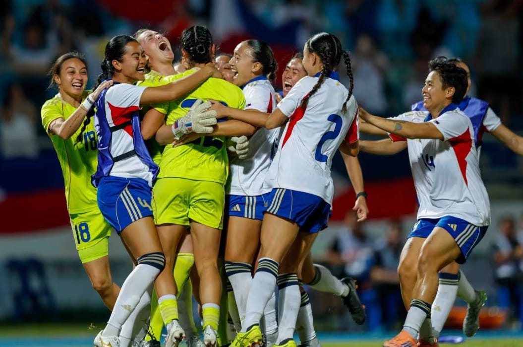 A group of Filipino female footballers in white and blue uniforms hugged each other and cheered with joy after winning the gold medal in the women's football at the 2025 SEA Games by defeating Vietnam in the final.