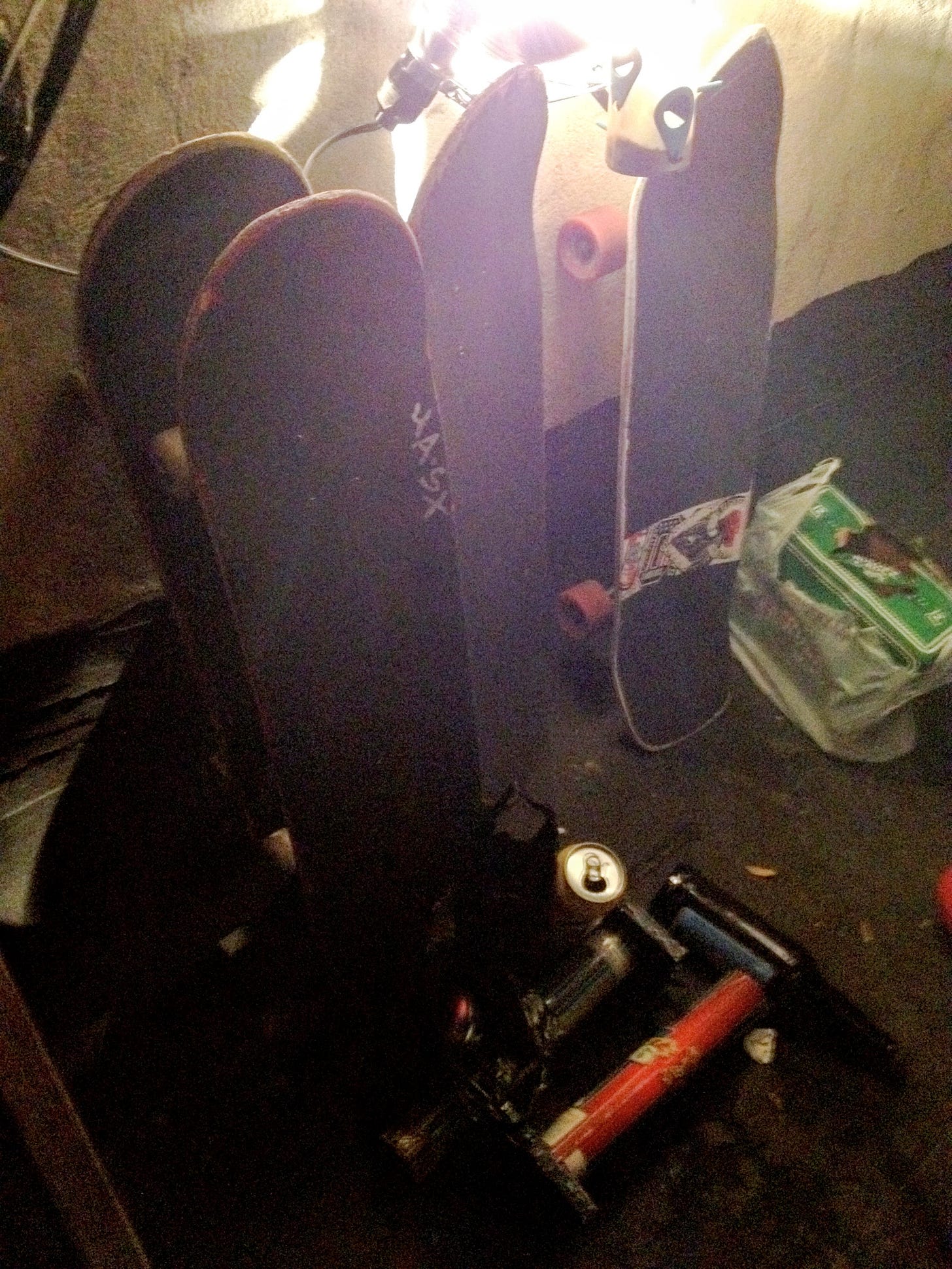 four skateboards leaning against a wall