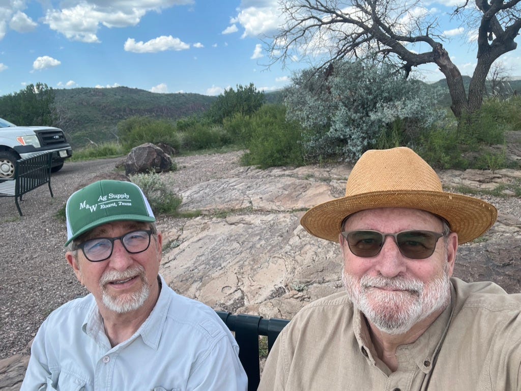 Two men sitting in a truck

Description automatically generated