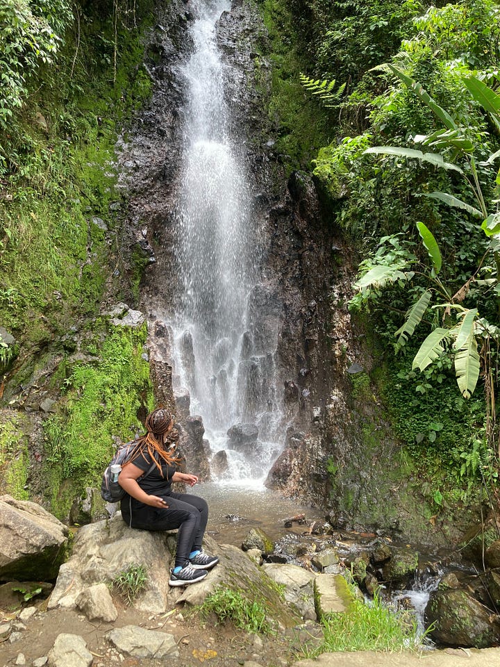 Zefan next to one of the waterfalls outside Jardin; A view of the green views in Jardin; Zefan inside the door of a cave about a 20 minute from Jardin (yes there were lots of bats); Jardin's church square looking extra lively for Catholic Easter