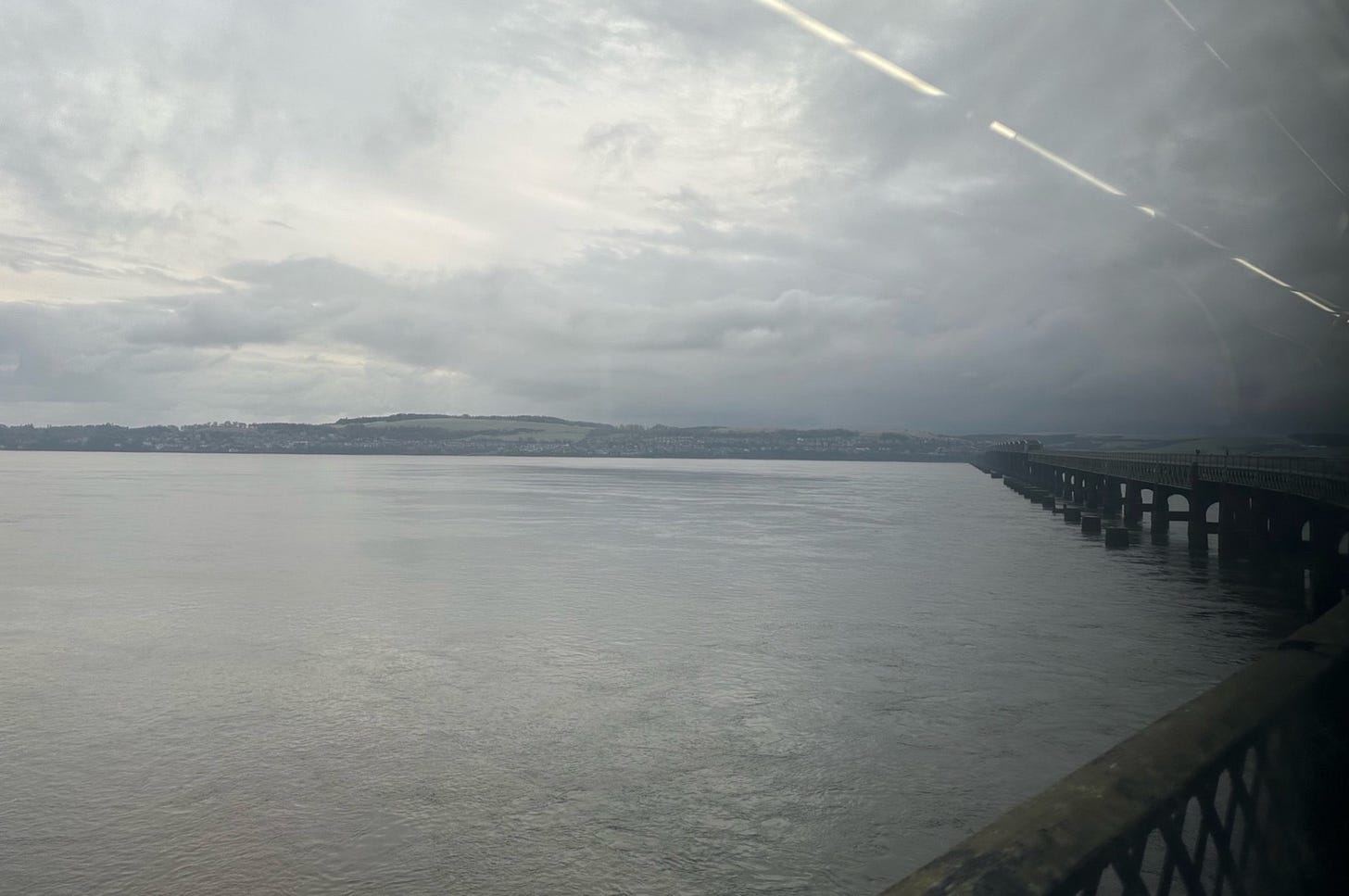 A photo from a bridge looking out over the Tay. The view is grey.