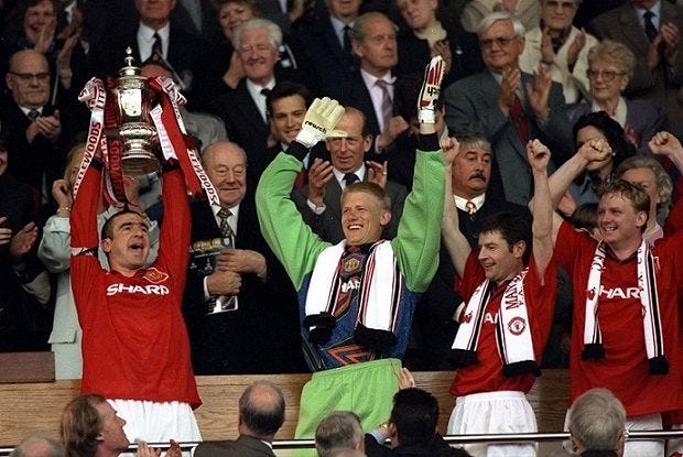 Eric Cantona holds aloft the trophy 11/5/1996
