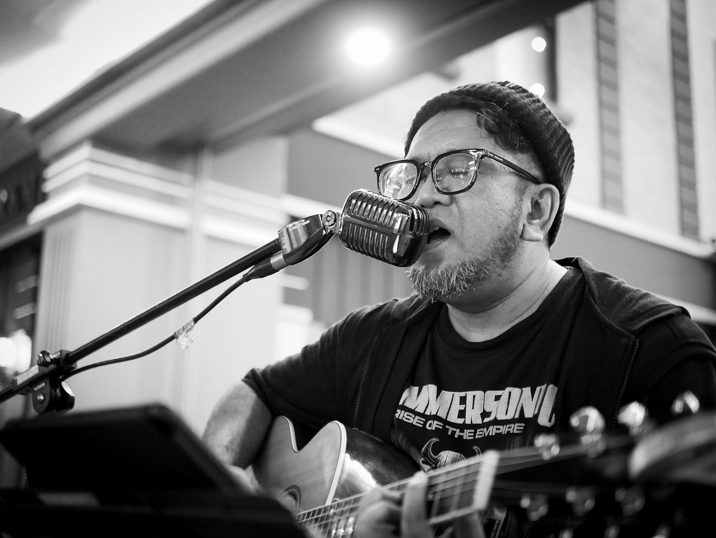 Dhendy Mawardi plays acoustic guitar