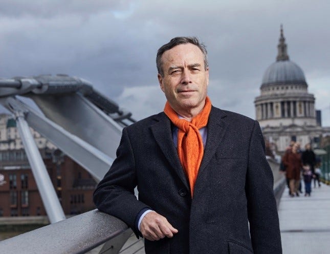 A person in a suit and orange scarf

AI-generated content may be incorrect.