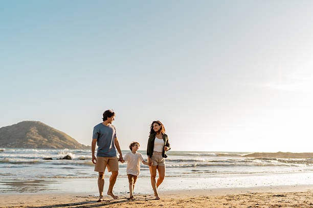 Family walking on the beach Family walking on the beach seaside stock pictures, royalty-free photos & images