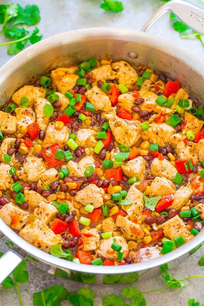 A salsa, black bean, and chicken skillet topped with scallions. 