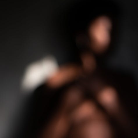 Three out of focus images of a black woman in light and shadow against a pale gold backdrop. In each image her arms take a different protective position about her head and upper body.