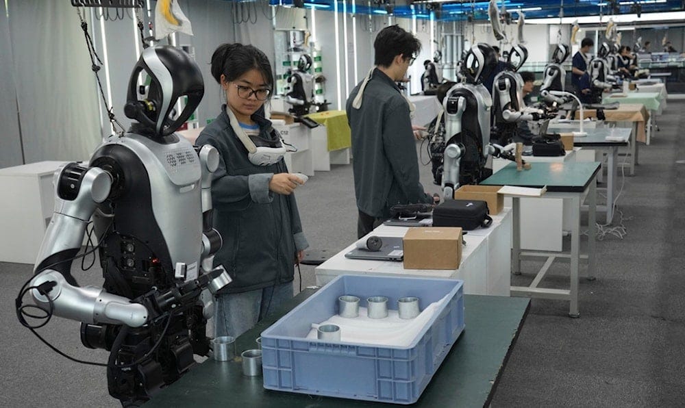 A worker remote controls humanoid robots during the one month countdown of 2026 China International Fair for Trade in Services (CIFTIS) at a robot training center in Beijing, China, Monday, Aug. 10, 2026. (AP Photo/Achmad Ibrahim) A worker remote controls humanoid robots during the one month countdown of 2026 China International Fair for Trade in Services (CIFTIS) at a robot training center in Beijing, China, Monday, Aug. 10, 2026. (AP Photo/Achmad Ibrahim)
