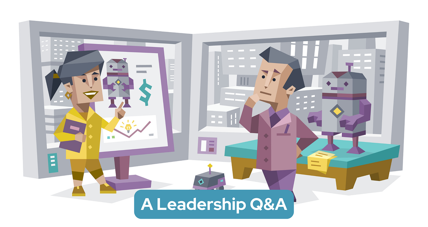 A woman presents designs for a robot on a large screen, while a man stands nearby beside a prototype of the robot, deep in thought. Text in a blue banner reads: A Leadership Q&A A woman presents designs for a robot on a large screen, while a man stands nearby beside a prototype of the robot, deep in thought. Text in a blue banner reads: A Leadership Q&A