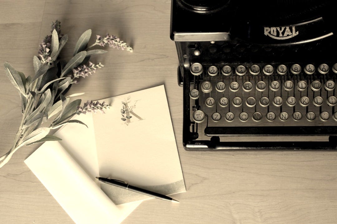 white printer paper on black typewriter white printer paper on black typewriter