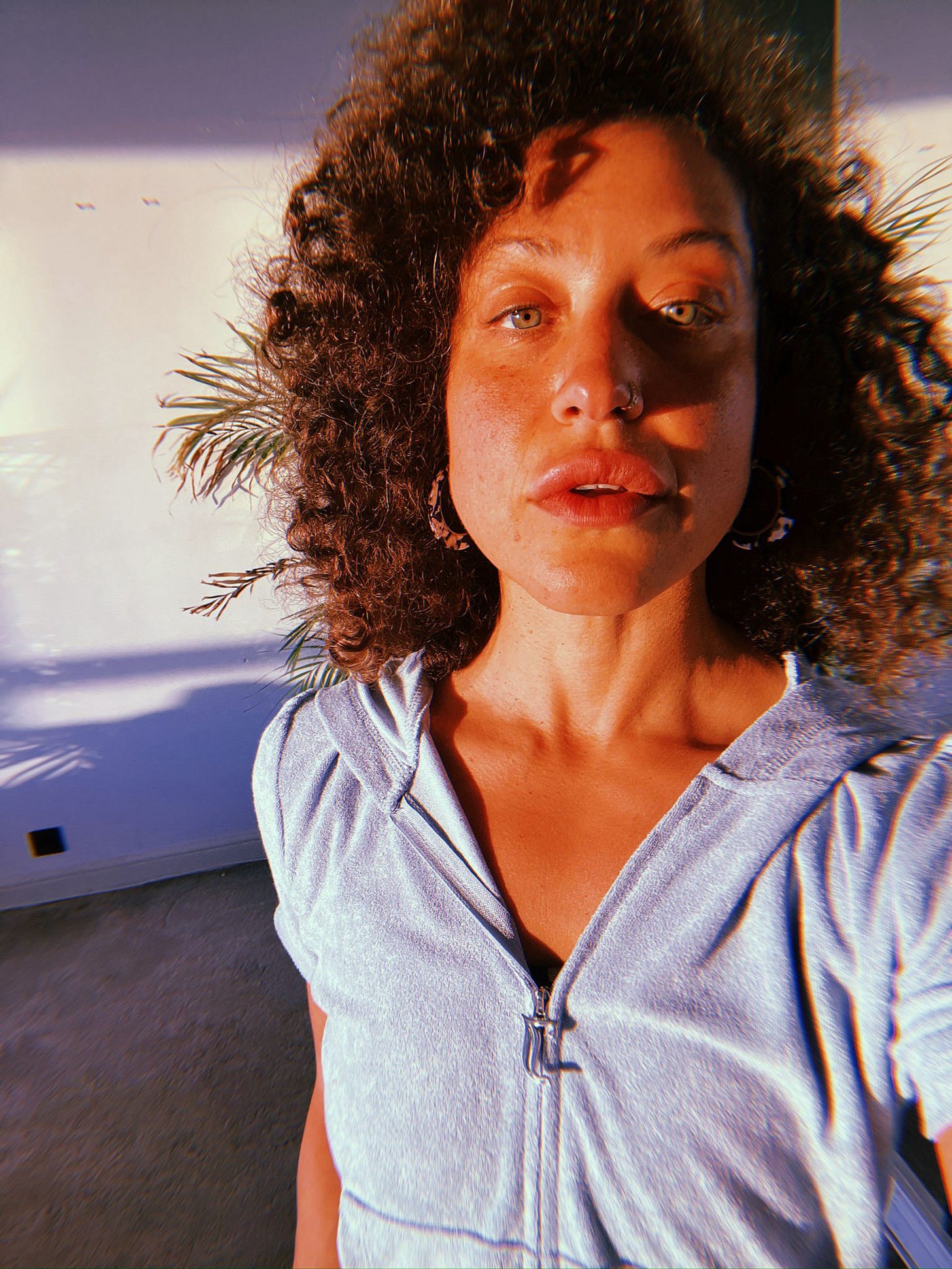 A picture of Leigh Alexander standing in a sunbeam